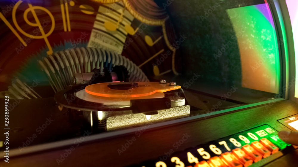 Retro music box, bar customer choosing favorite melody, entertainment nostalgia Stock Photo