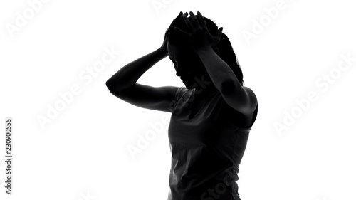 Beautiful lady suffering from migraine, symptom of premenstrual syndrome, shadow photo