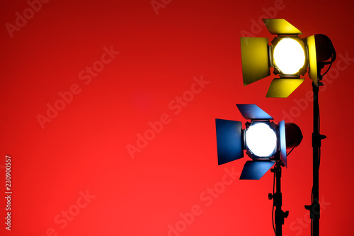 Equipment for photo studios and fashion photography. Red colored background and blue yellow light.