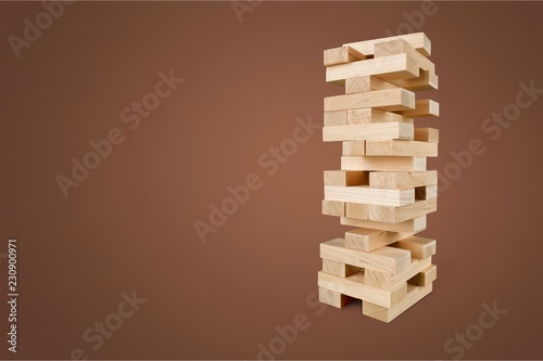 Tower of wooden cubes from table game over grey background