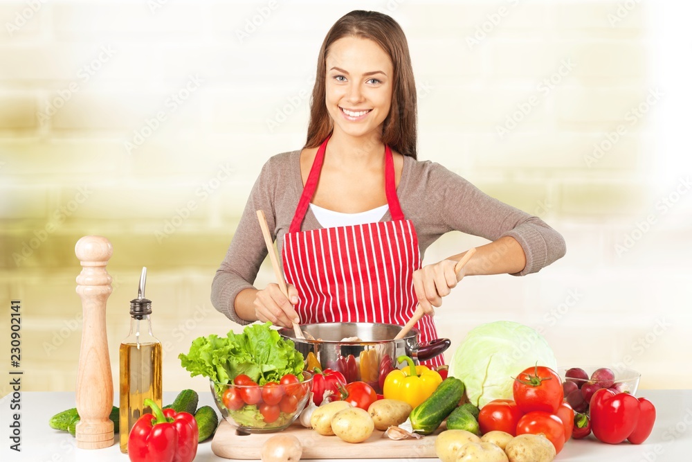 Young beautiful woman with fresh vegetables cooking