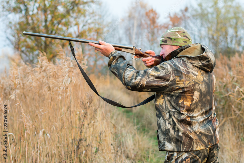 Fototapeta premium hunter, a man with a gun in the woods