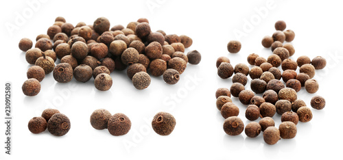 Set with allspice pepper corns on white background