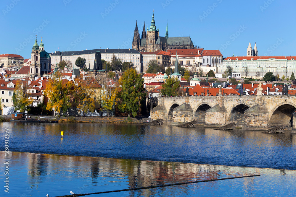 Colorful autumn Prague gothic Castle and Charles Bridge with the Lesser Town in the sunny Day, Czech Republic