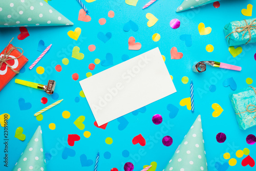 Festive frame or bright background, gift, confetti, carnival hat and streamer. Flat style. Birthday or holiday card with a copy.