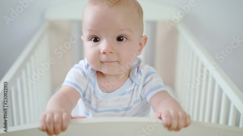 Cute baby Standing in her crib at home. Close-up shot