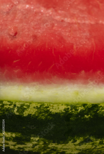 background. delicious red watermelon with black seeds and green skin