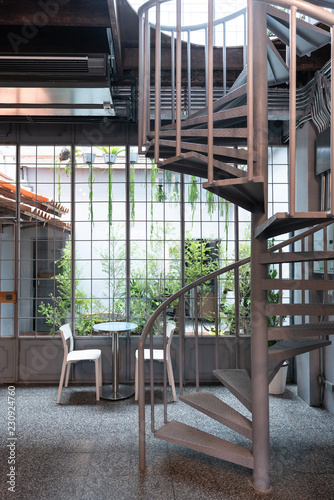 Cozy Dining Space In Natural Light Scene With Small Garden In The Background And Spiral Metal Stair On Foreground Cafe Concept Natural Light Concept Interior Design Stock Photo Adobe Stock