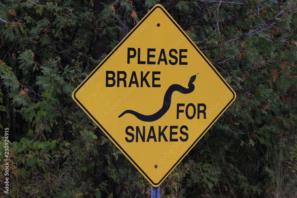 Please break for snakes signpost, important so snakes can cross roads