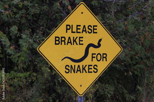 Please break for snakes signpost, important so snakes can cross roads safely during mating season