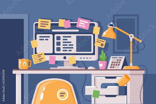 Cluttered workplace with computer pasted over with stickers.