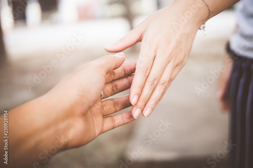 Two people holding hands for comfort. Giving a helping hand.