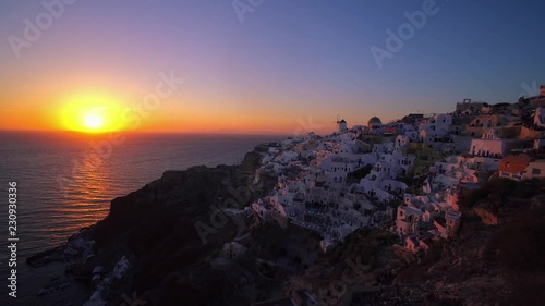 People watching sunset over beautiful town of Oia on the Island of Santorini.