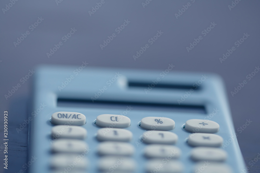 Calculator on the table,finance and business concept,Money,soft focus and blurred style,dark tone. Calculator on the table,finance and business concept,Money,soft focus and blurred style,dark tone.