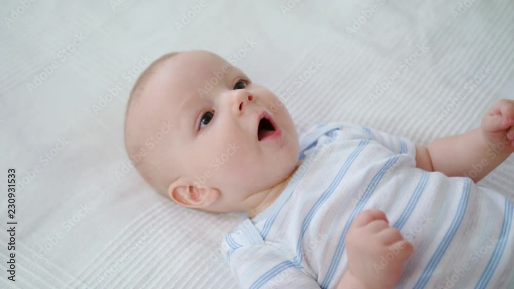 Cute baby lying in her bed at home. Close-up shot Cute baby lying in her bed at home. Close-up shot