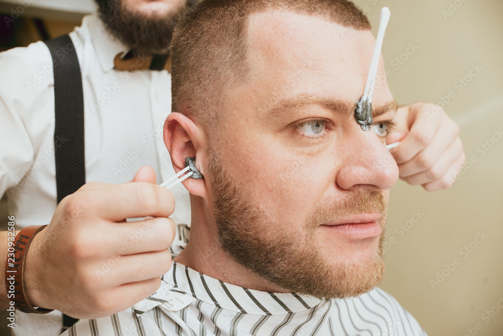 Waxing. Hair removal in the ears. Pulling hair from ears Stock Photo |  Adobe Stock