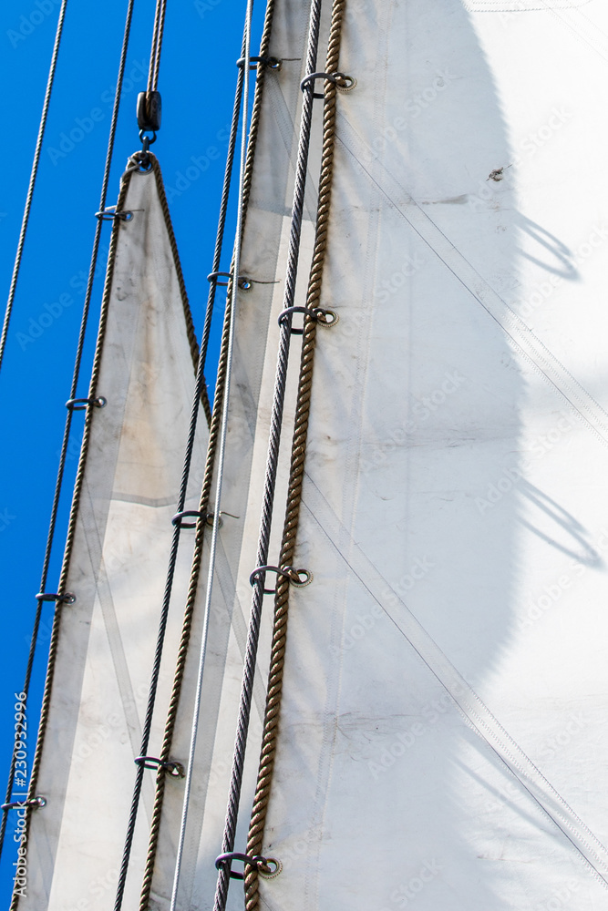Obraz premium Metal rings attach the three jibs to the rigging on a bowsprit of a 3-masted schooner on its way to the Island of Nicklösa in the Åland Islands, Finland.
