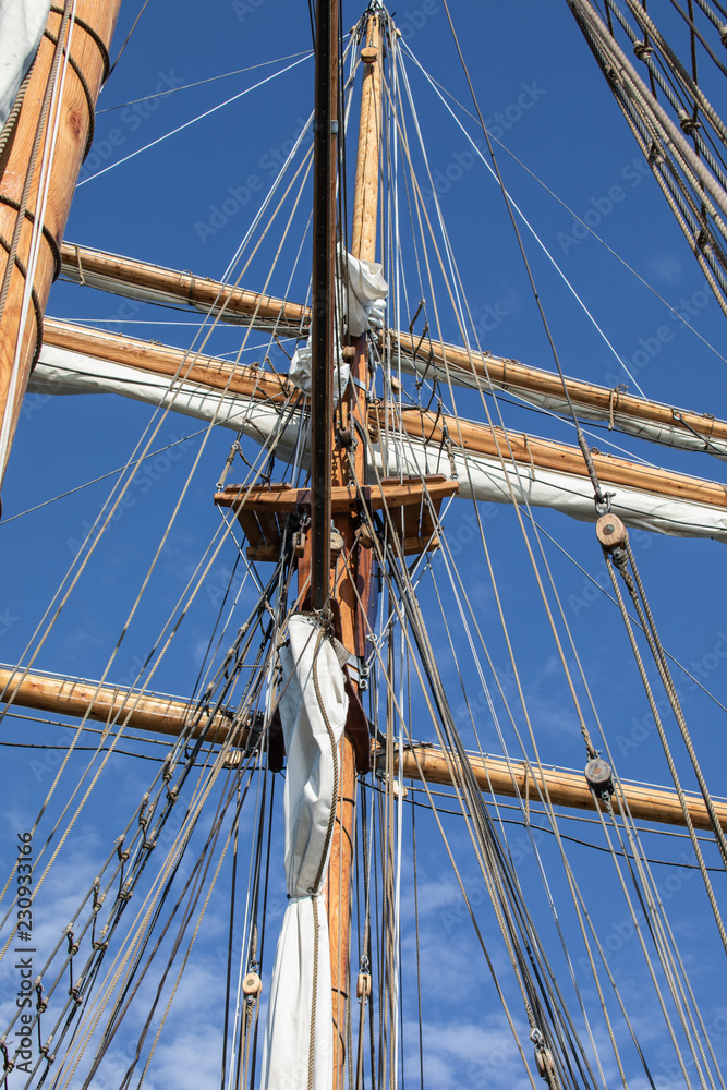 Looking at a mast, yard, furled sails, and rigging of a 3-masted schooner on its way to the Island of Nicklösa in the Åland Islands, Finland. Looking at a mast, yard, furled sails, and rigging of a 3-masted schooner on its way to the Island of Nicklösa in the Åland Islands, Finland.