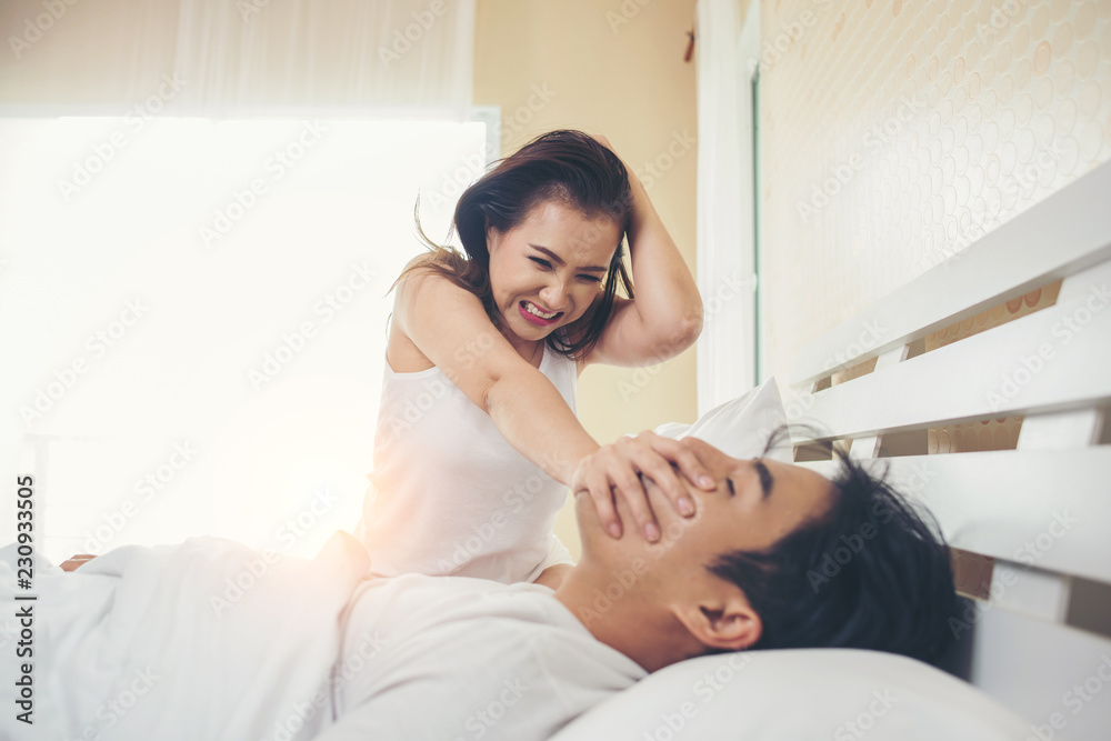 Young woman bored with her boyfriend snoring Young woman bored with her boyfriend snoring