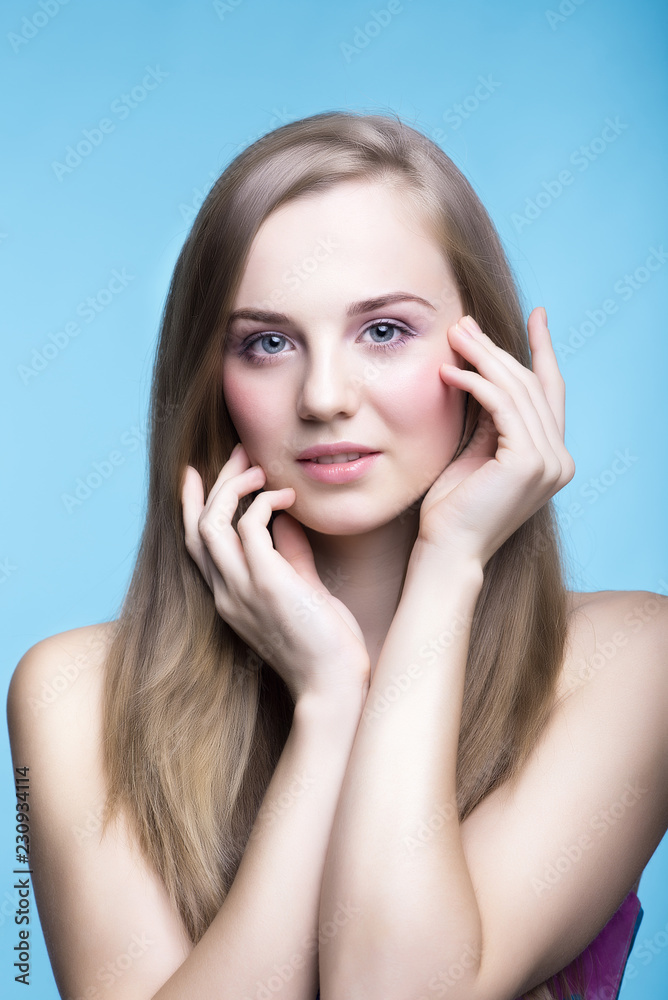 Beautiful young girl on the blue background Beautiful young girl on the blue background