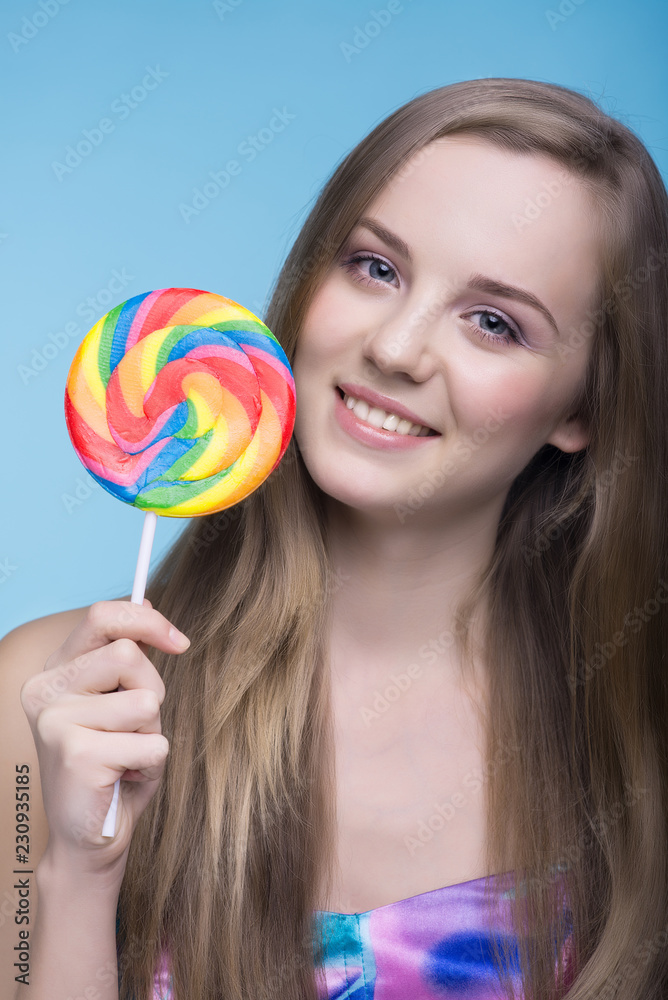 Beautiful young women with multicolors lollipop