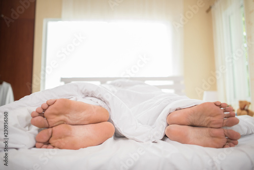Feet of couple facing away from each other.