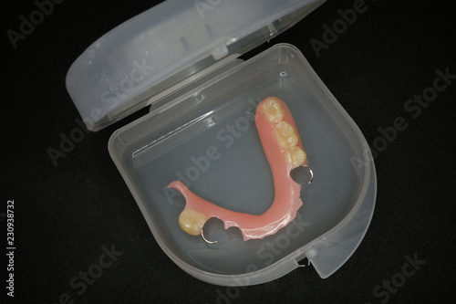 lower denture in box on black background