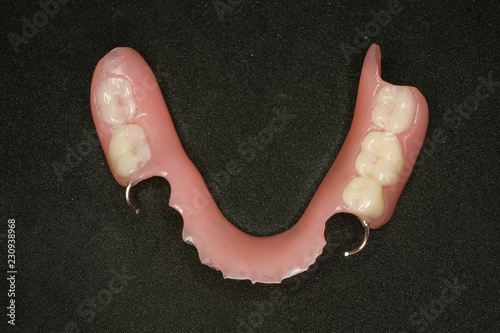 lower denture and wires on black background