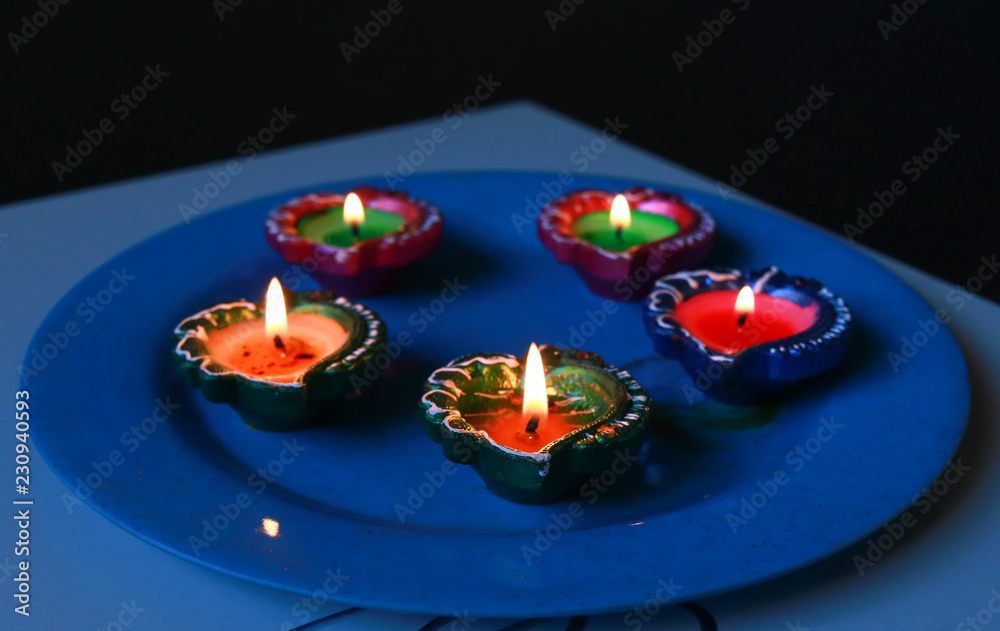 Colourful diyas placed on plate