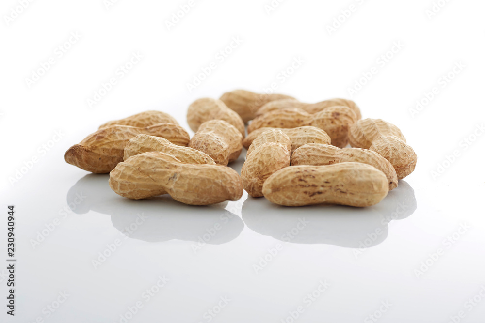 Peanuts. unpeeled nuts isolated on white background. Peanut macro. Selective Focus Peanuts. unpeeled nuts isolated on white background. Peanut macro. Selective Focus