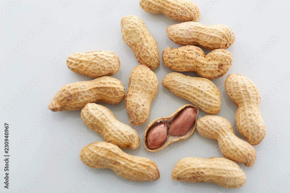 Peanuts. unpeeled nuts isolated on white background. Peanut macro. Selective Focus Peanuts. unpeeled nuts isolated on white background. Peanut macro. Selective Focus