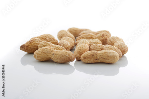 Peanuts.  unpeeled nuts isolated on white background. Peanut macro. Selective Focus