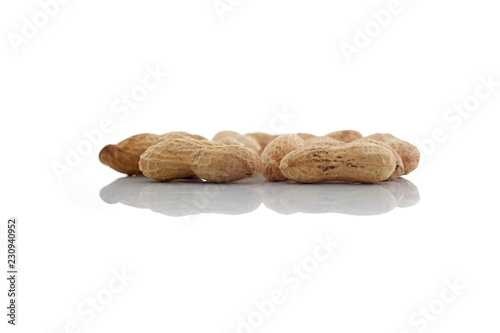 Peanuts.  unpeeled nuts isolated on white background. Peanut macro. Selective Focus