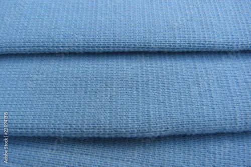 blue knitted fabric closeup background wool acrylic canvas material for clothing