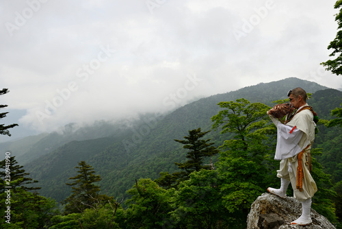 Man wearing traditional clothing blowing instrument