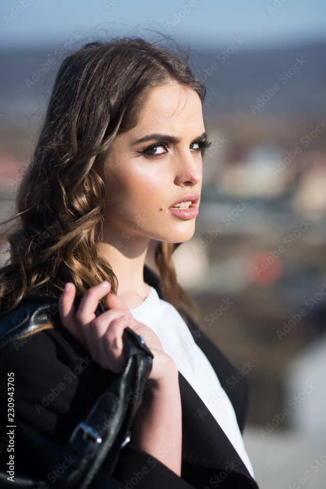 Pretty girl with fashionable hair. Fashion woman with stylish makeup and curly hair. autumn fashion of business woman with bag. Beauty and fashion look. Loving her new style. Young and free
