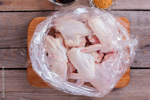 Obraz na plátně Step-by-step cooking of chicken wings with spices and soy sauce in a baking bag,