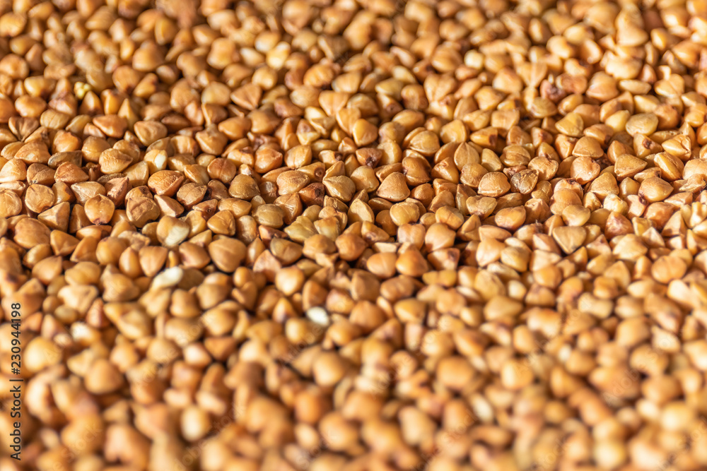 Groat buckwheat raw macro. Diet food concept. Background with focus shallow depth of field. Groat buckwheat raw macro. Diet food concept. Background with focus shallow depth of field.