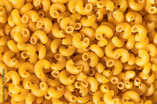 Pasta penne uncooked top view. Soft focus for general background. Italian design, texture.