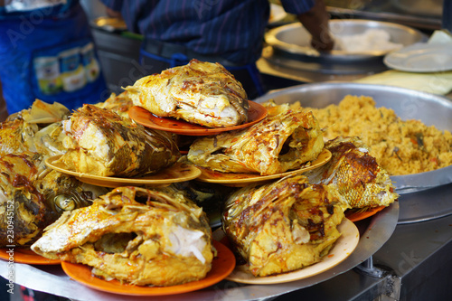 The famous snapper fish head curry arranged on a plate.