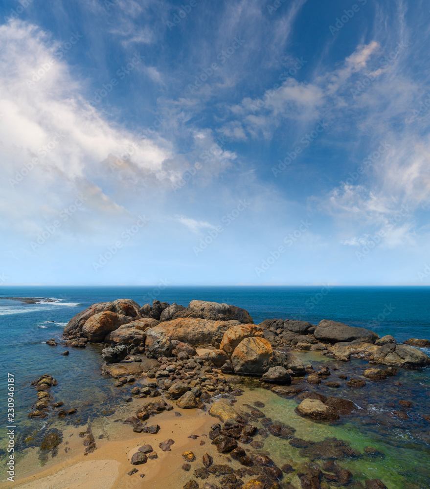 Large rocks in ocean near shore.