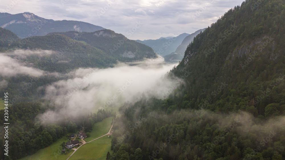 Obraz premium Aerial view of the morning foggy landscape in the alpine mountains