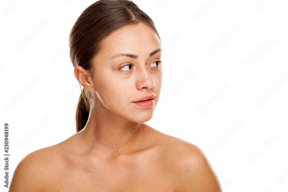 Portrait of young beautiful serious woman with no makeup on white backgeound Portrait of young beautiful serious woman with no makeup on white backgeound