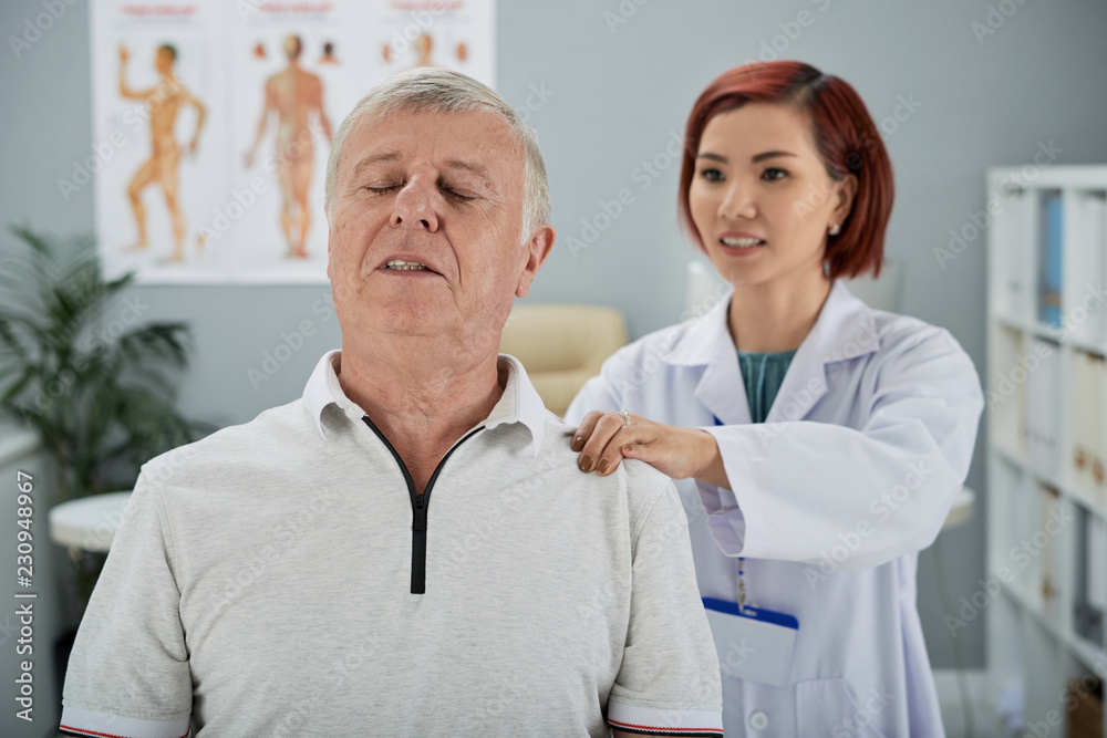 Senior man with acute pain in back visiting doctor Senior man with acute pain in back visiting doctor