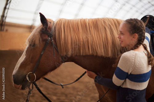 Horse and teen girl - best friends. Learning equestrian