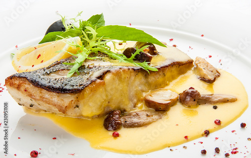 Obraz na plátně Pike perch with porcini mushrooms and potatoes. On a white plate