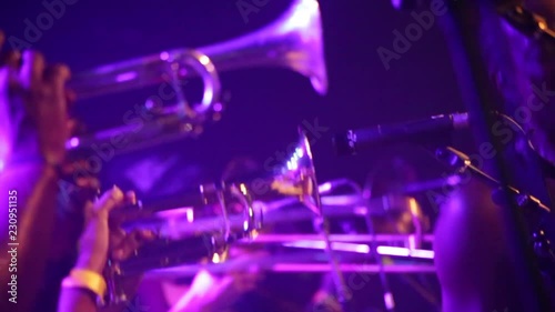 Row of trumpets on stage in purple stage lights