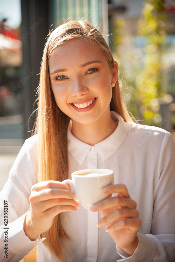 Business woman has a coffee break and drinks coffee in a bar Business woman has a coffee break and drinks coffee in a bar