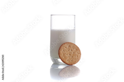 fresh milk in the glass on white background with cookies, isolated