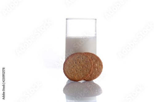 fresh milk in the glass on white background with cookies, isolated photo